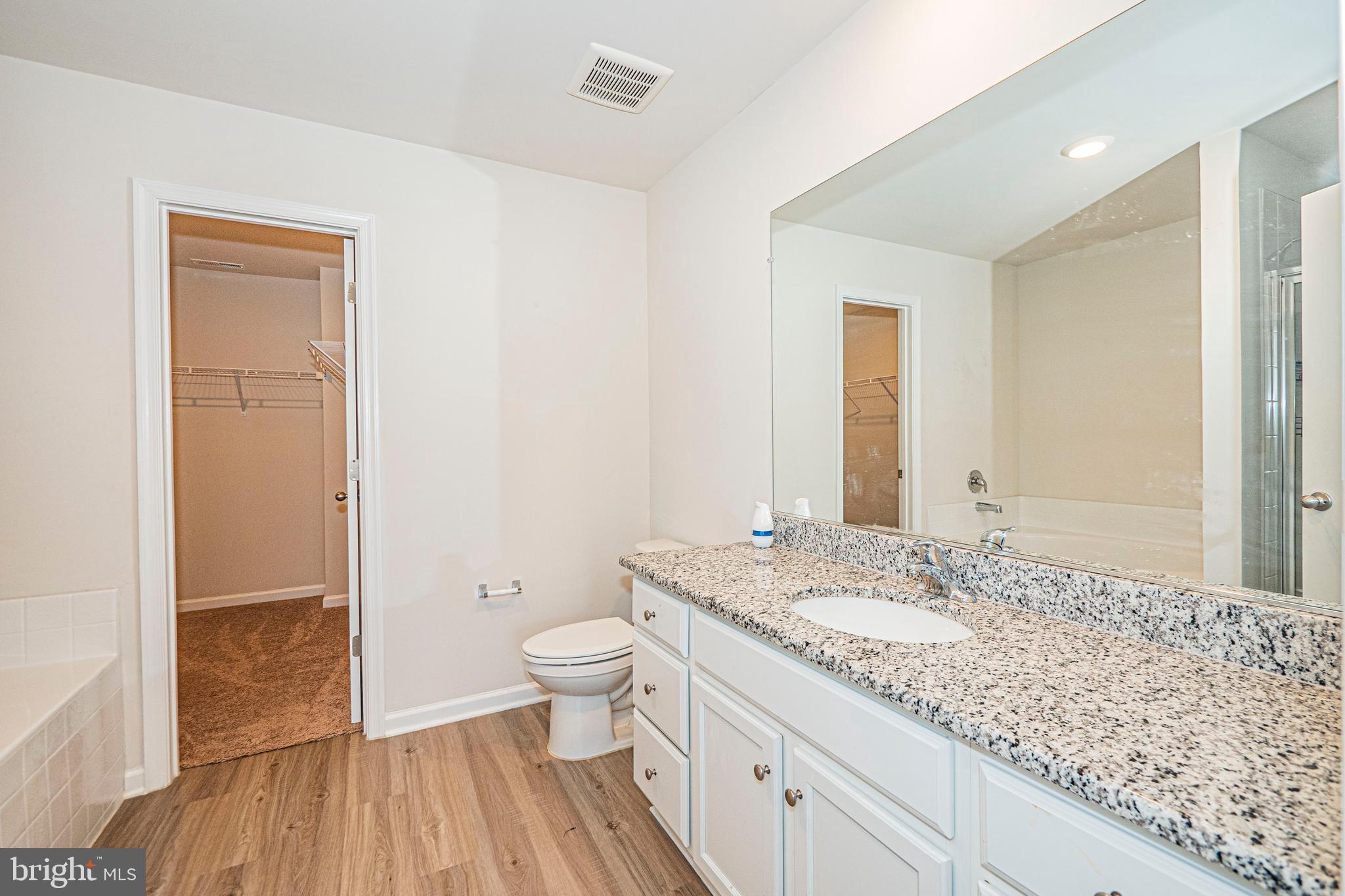 120 Paddington Street Falling Waters, WV 25419 - Photo 19 of 34 a bathroom with a granite countertop sink a toilet and a shower