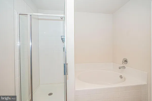 a spacious bathroom with a granite countertop sink toilet and mirror