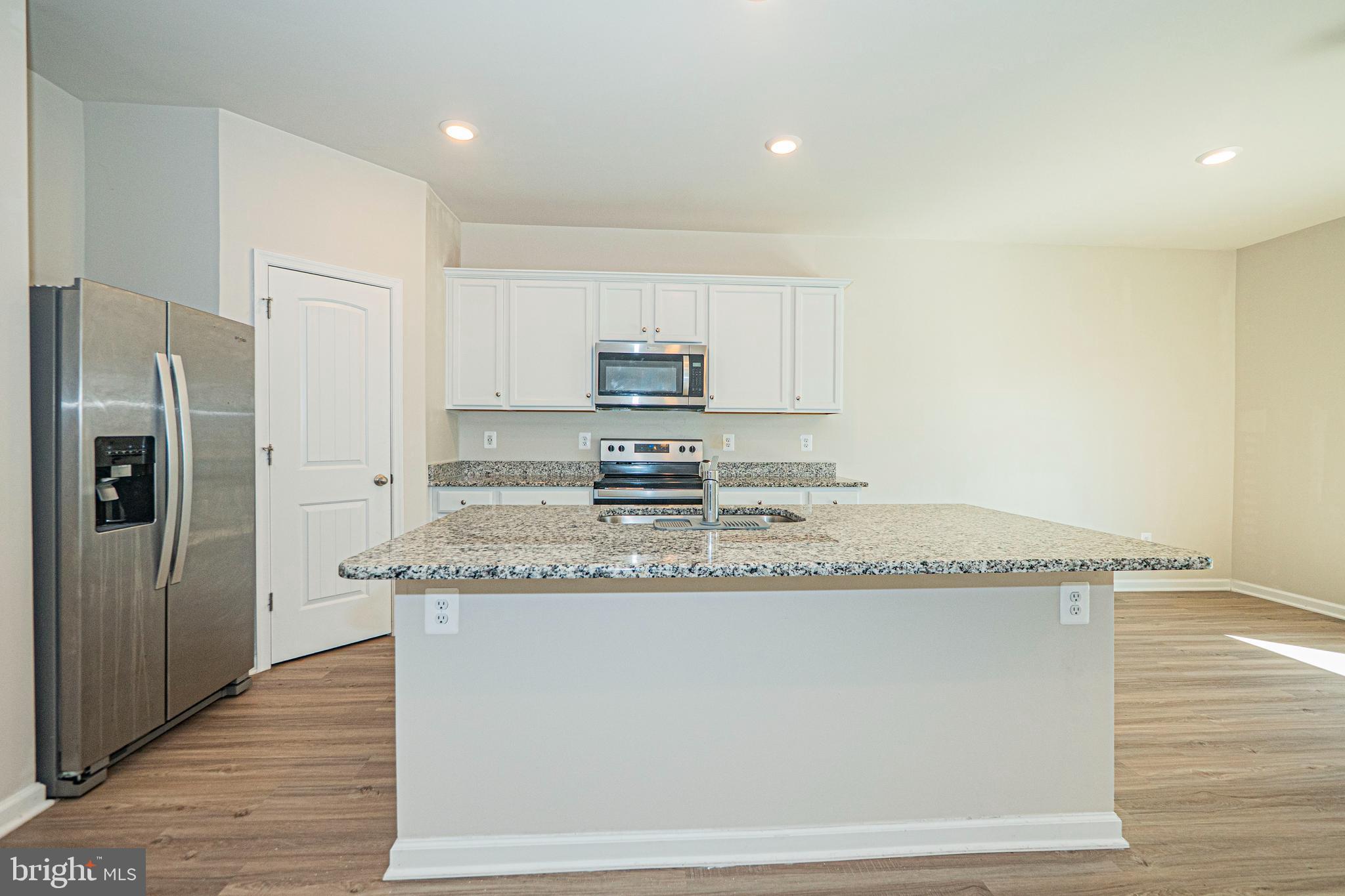 120 Paddington Street Falling Waters, WV 25419 - Photo 3 of 34 a kitchen with granite countertop a sink a refrigerator and a stove