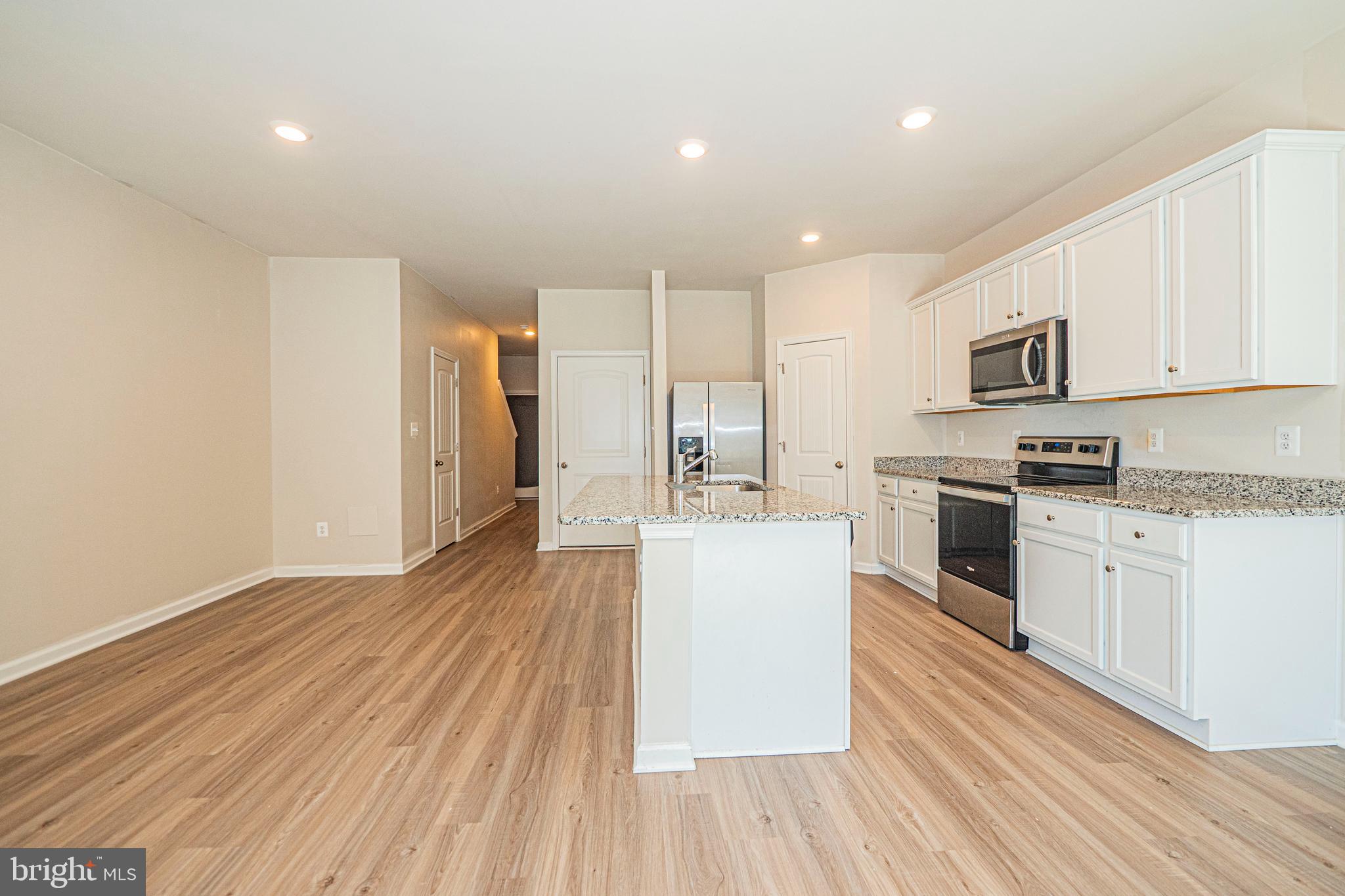 120 Paddington Street Falling Waters, WV 25419 - Photo 4 of 34 a kitchen with granite countertop a stove top oven a sink dishwasher and a refrigerator with wooden floor