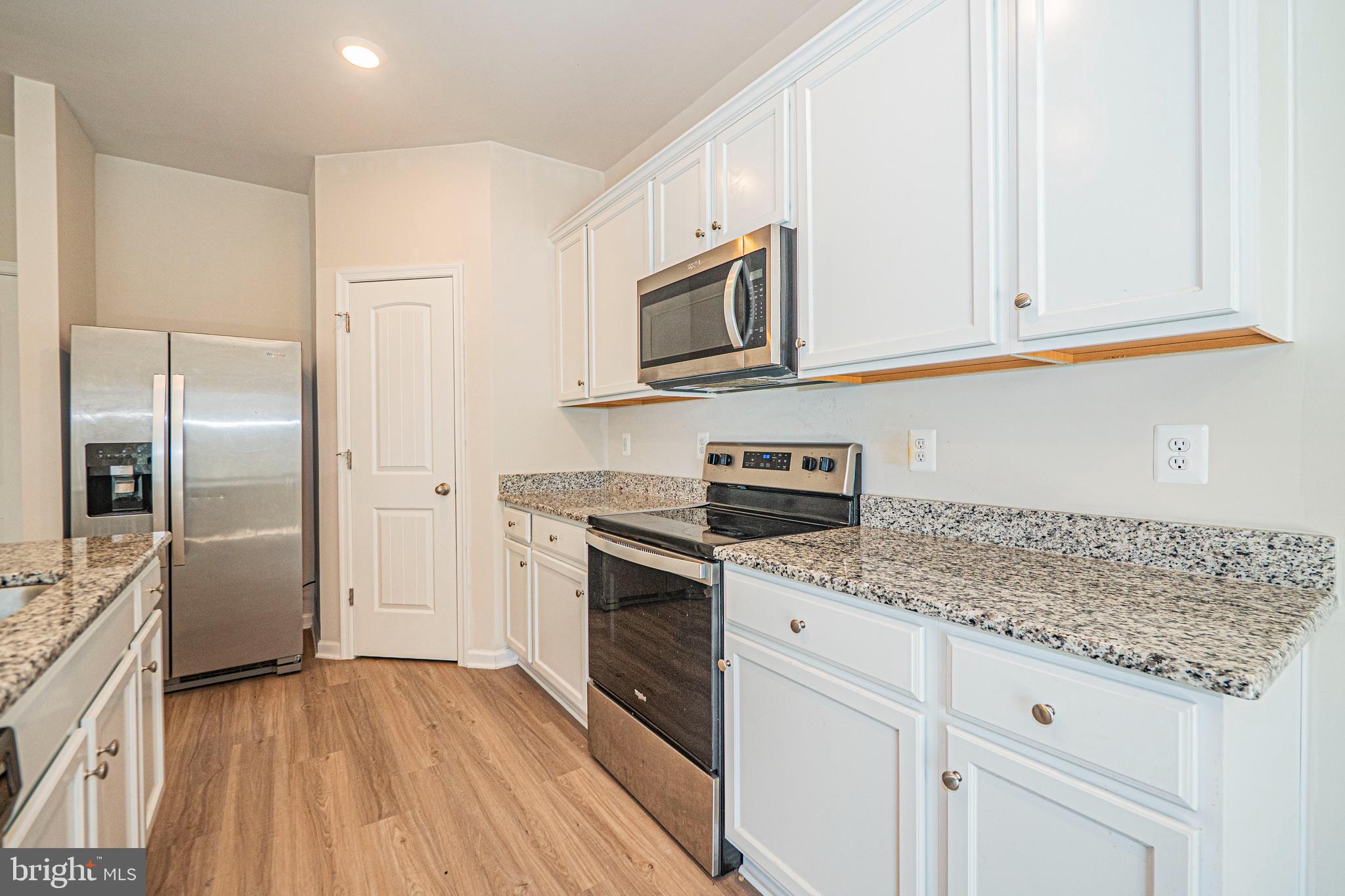 120 Paddington Street Falling Waters, WV 25419 - Photo 5 of 34 a kitchen with stainless steel appliances granite countertop a refrigerator and microwave