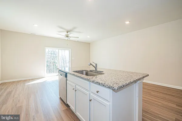 a hallway with sink and mirror