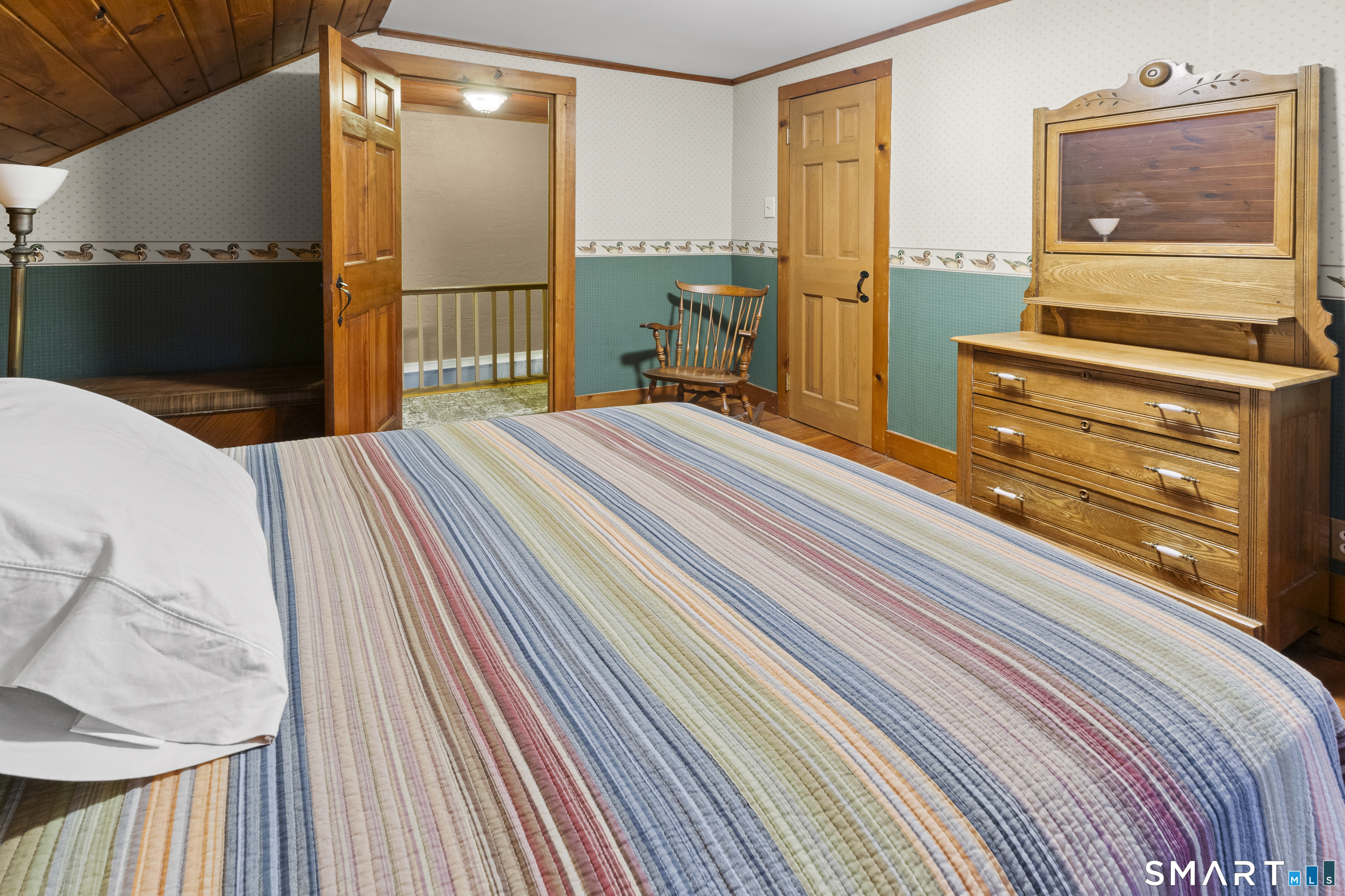 204 Paine Road Pomfret, CT 06259 - Photo 26 of 32 a bedroom with a bed and wooden floor