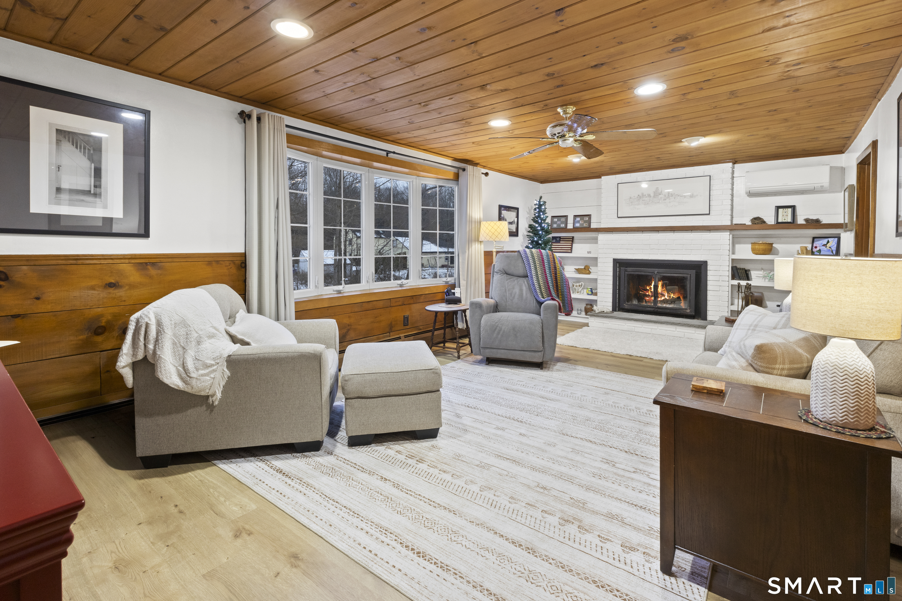 204 Paine Road Pomfret, CT 06259 - Photo 8 of 32 a living room with furniture a fireplace and a large window