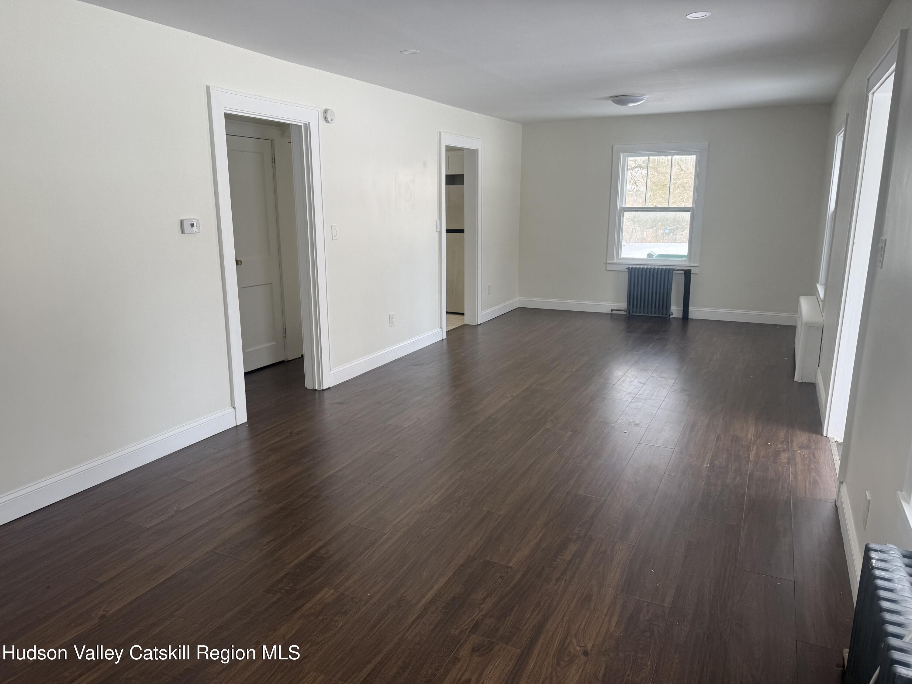 222 Zandhoek Road Hurley, NY 12443 - Photo 6 of 23 an empty room with wooden floor and windows