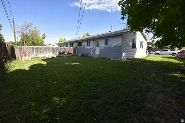 290 West 600 North Logan, UT 84321 - Photo 3 of 45 Expansive lawn area enclosed by a wood plank fence