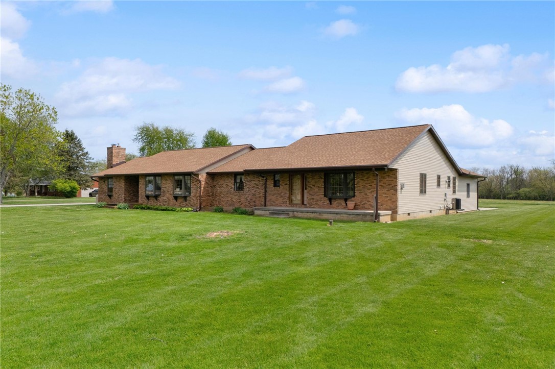 4971 Lackey Road Cedarville, OH 45314 - Photo 2 of 79 This ranch-style home is nestled on a spacious green lawn, offering a serene countryside setting.
