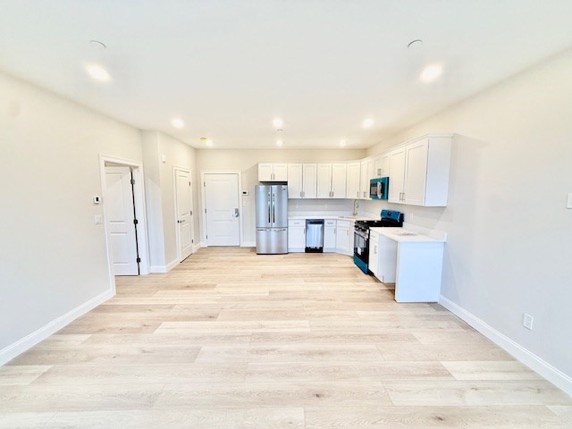 220 Winthrop Street, Unit 304 Winthrop, MA 02152 - Photo 1 of 11 a large white kitchen with kitchen island a sink stainless steel appliances and cabinets