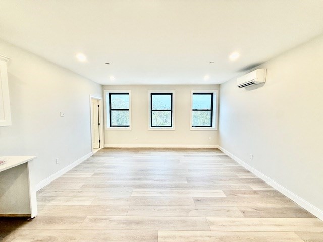 220 Winthrop Street, Unit 304 Winthrop, MA 02152 - Photo 6 of 11 a view of an empty room with wooden floor and windows