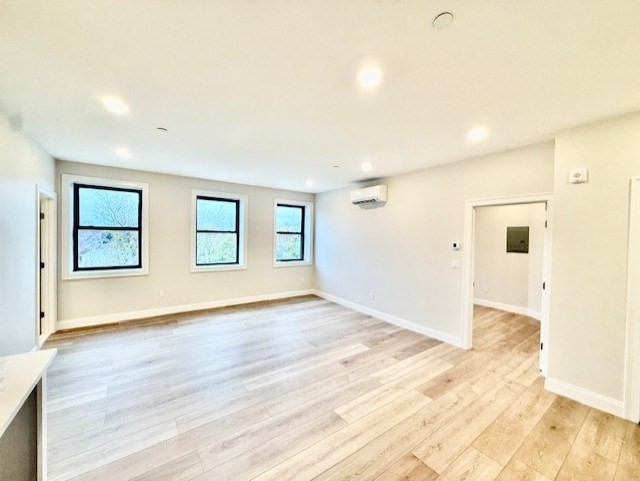 220 Winthrop Street, Unit 304 Winthrop, MA 02152 - Photo 7 of 11 a view of an empty room with wooden floor and a window