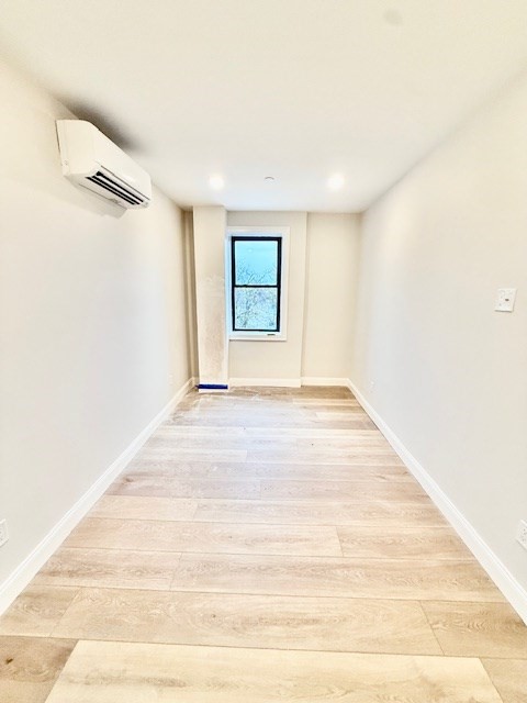 220 Winthrop Street, Unit 304 Winthrop, MA 02152 - Photo 9 of 11 a view of an empty room with wooden floor and a window