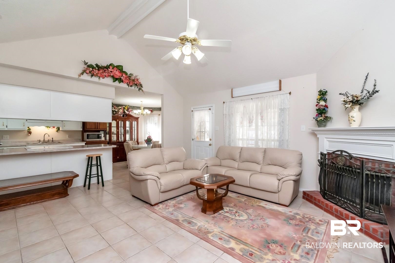 8221 Woodbend Drive Semmes, AL 36575 - Photo 10 of 35 Living room with light tile patterned floors, a brick fireplace, beam ceiling, ceiling fan with notable chandelier, and sink