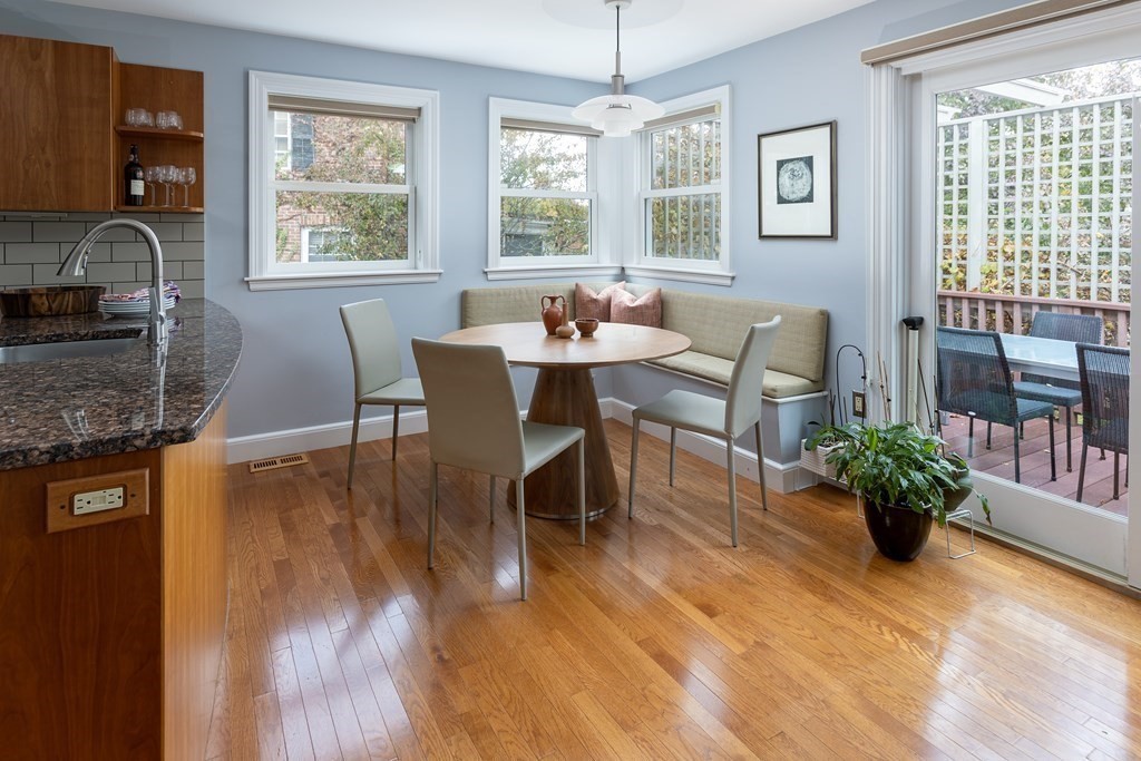 47 Arlington Road Brookline, MA 02467 - Photo 11 of 29 a dining room with furniture potted plants and wooden floor