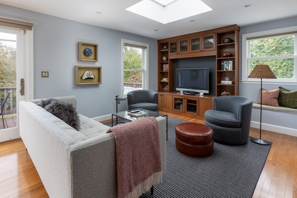 47 Arlington Road Brookline, MA 02467 - Photo 13 of 29 a living room with furniture a flat screen tv and a fireplace