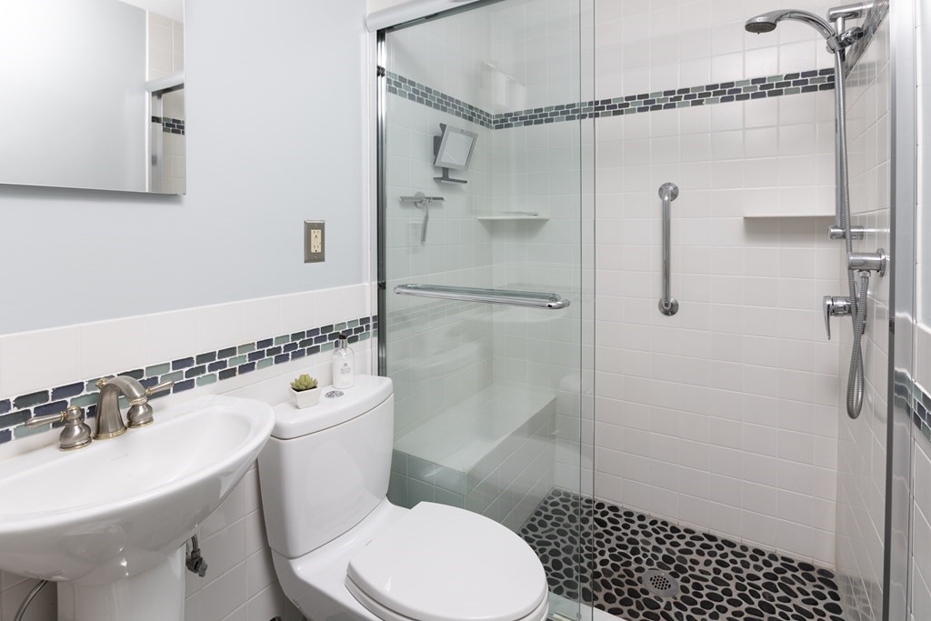 47 Arlington Road Brookline, MA 02467 - Photo 17 of 29 a white toilet sitting next to a bathroom sink