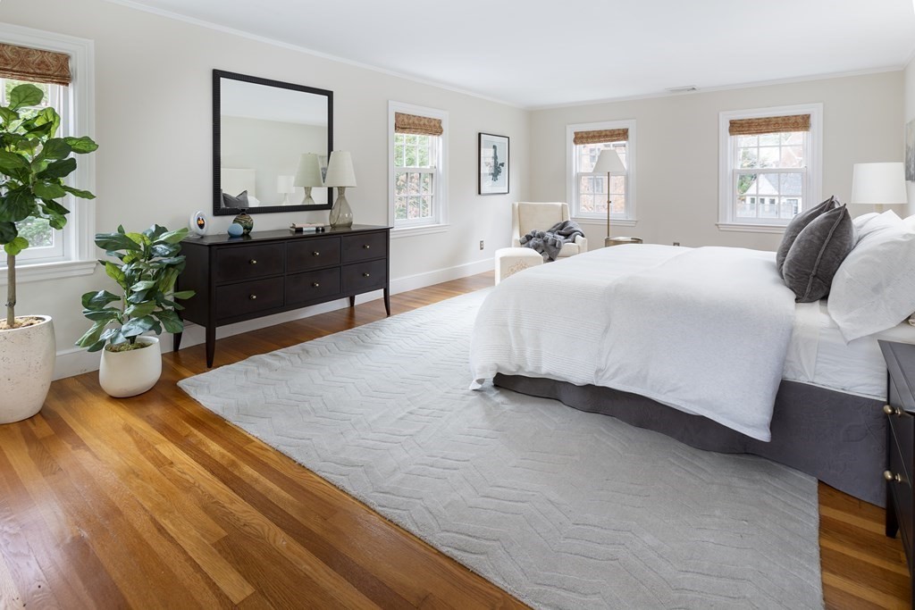 47 Arlington Road Brookline, MA 02467 - Photo 18 of 29 a bedroom with a bed and a potted plant
