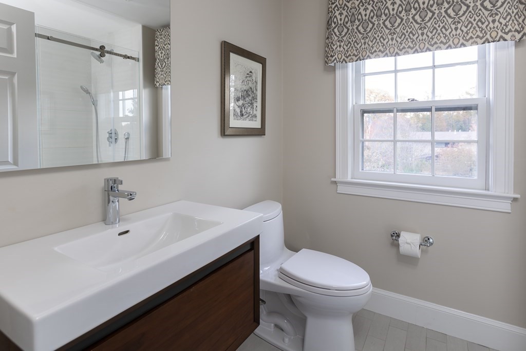 47 Arlington Road Brookline, MA 02467 - Photo 19 of 29 a bathroom with a sink a toilet and a mirror