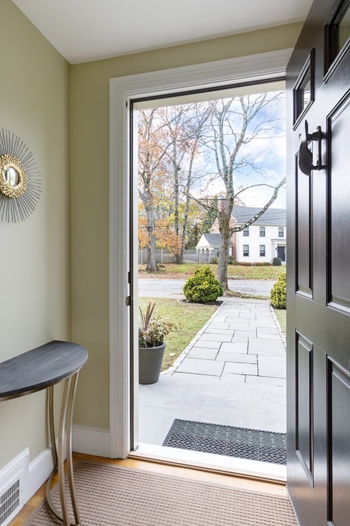47 Arlington Road Brookline, MA 02467 - Photo 8 of 29 a view of a porch with a floor to ceiling window and wooden floor