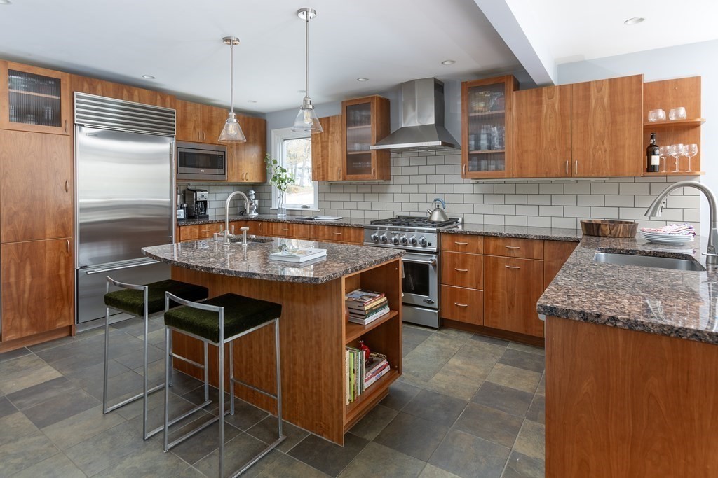 47 Arlington Road Brookline, MA 02467 - Photo 10 of 29 a kitchen with granite countertop a sink a counter space and cabinets