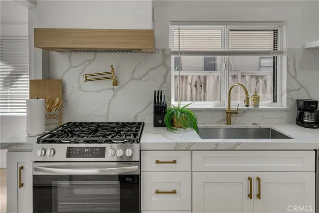 a bedroom with a large bed a bookshelf and a potted plant