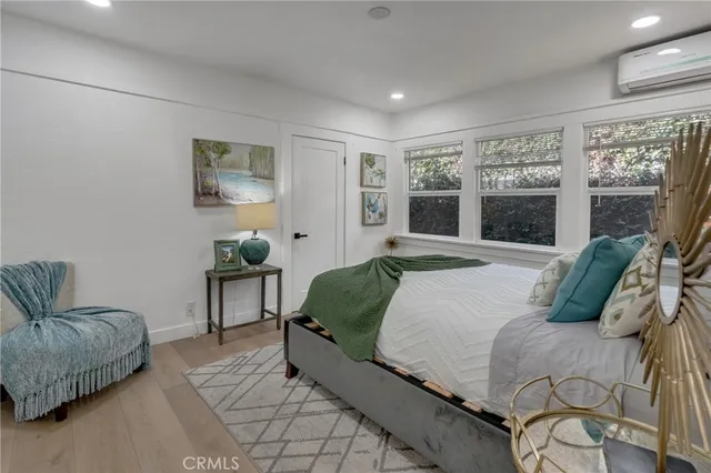 a large bed sitting in a bedroom next to a lamp