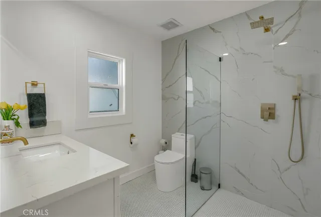 a living room with a fireplace a flat screen tv and a table