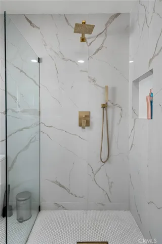 a living room with furniture a dining table and a chandelier