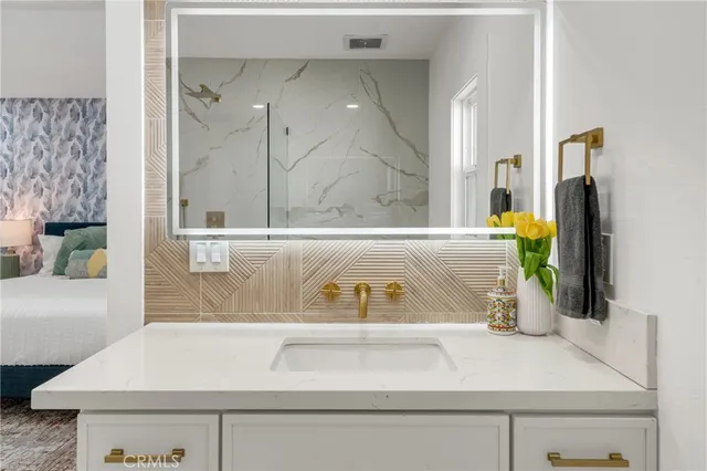 a living room with furniture potted plant and a chandelier