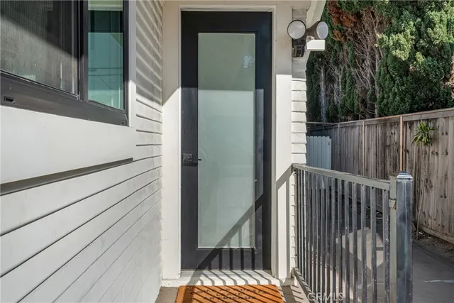 a view of a sink and dishwasher in a white cabinet