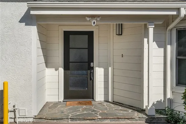 a view of a backyard with table and chairs and wooden fence