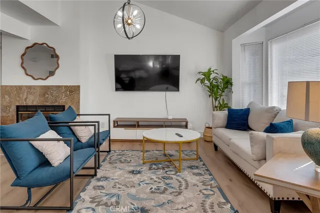 a view of a backyard with potted plants and large tree