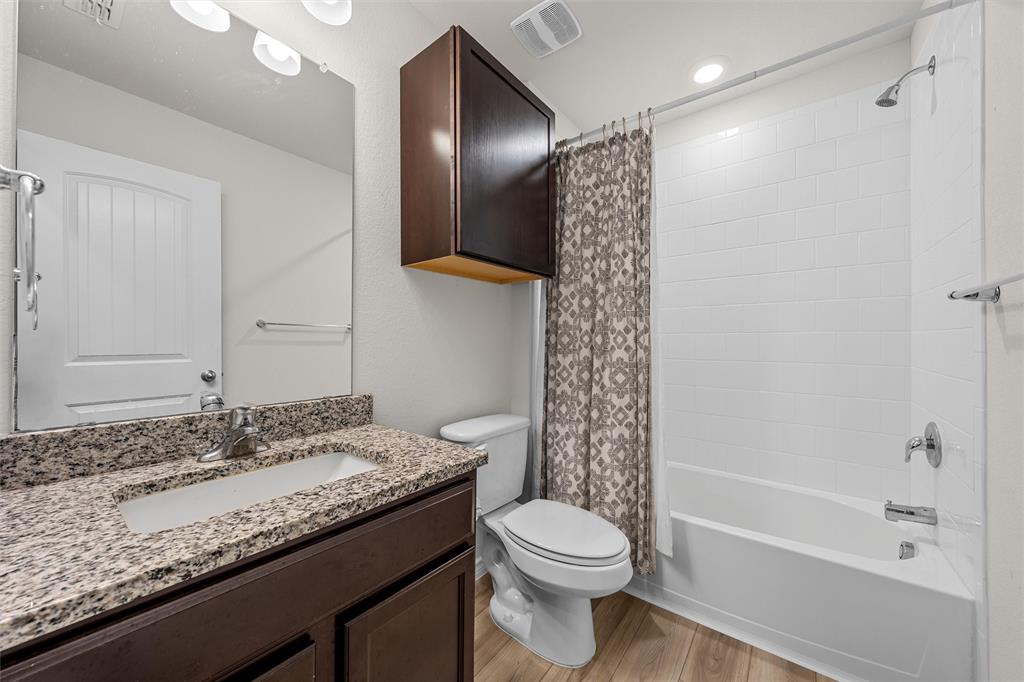 10712 Peperak Court Waco, TX 76708 - Photo 19 of 25 a bathroom with a granite countertop sink toilet and shower