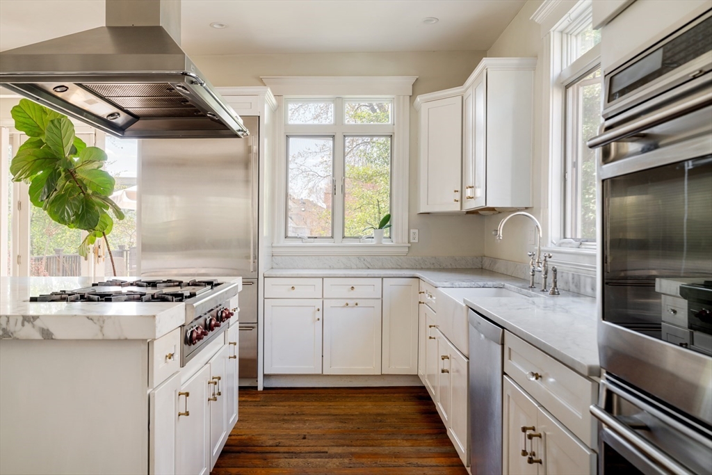 70 Oxford Street Somerville, MA 02143 - Photo 4 of 38 a kitchen with stainless steel appliances granite countertop a sink stove and cabinets