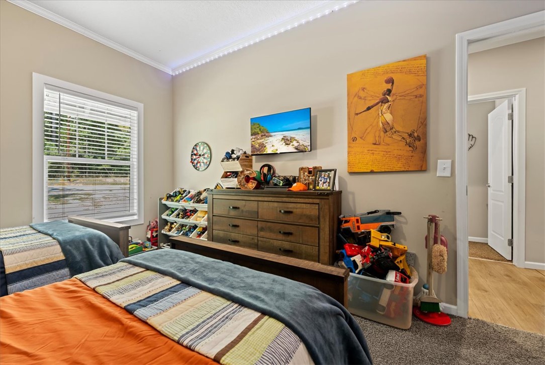 116 Parkview Road Iva, SC 29655 - Photo 29 of 44 Naturally illuminated by a large window, this bedroom offers carpet flooring and crown molding.