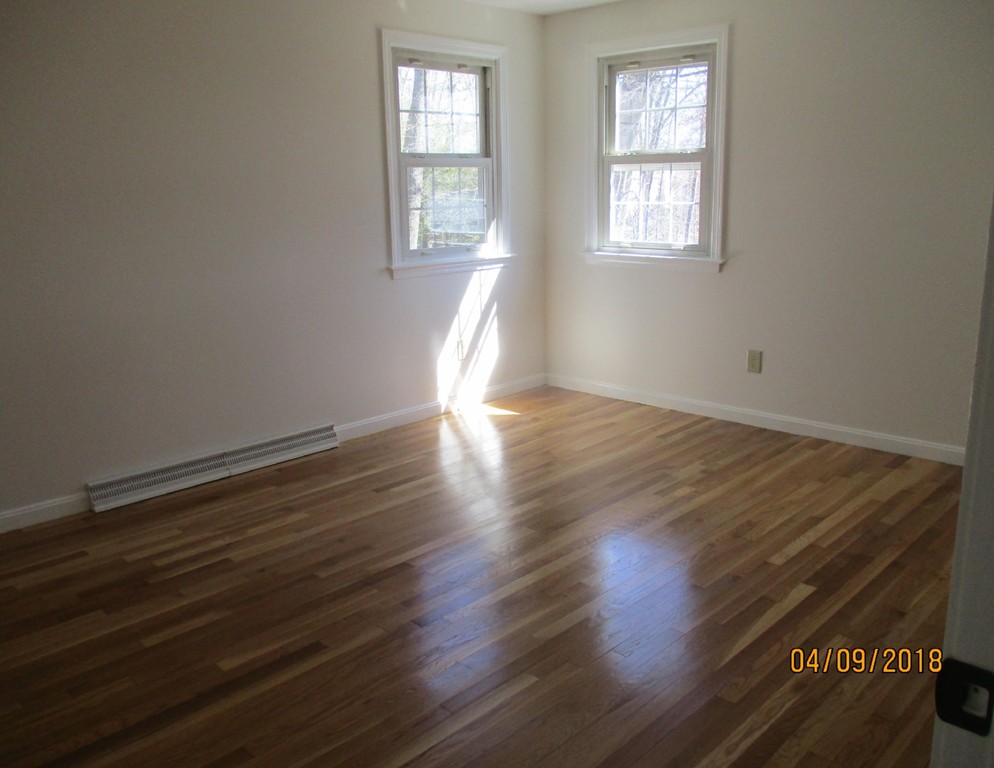 165 Swift Road Northbridge, MA 01588 - Photo 13 of 24 an empty room with wooden floor and windows