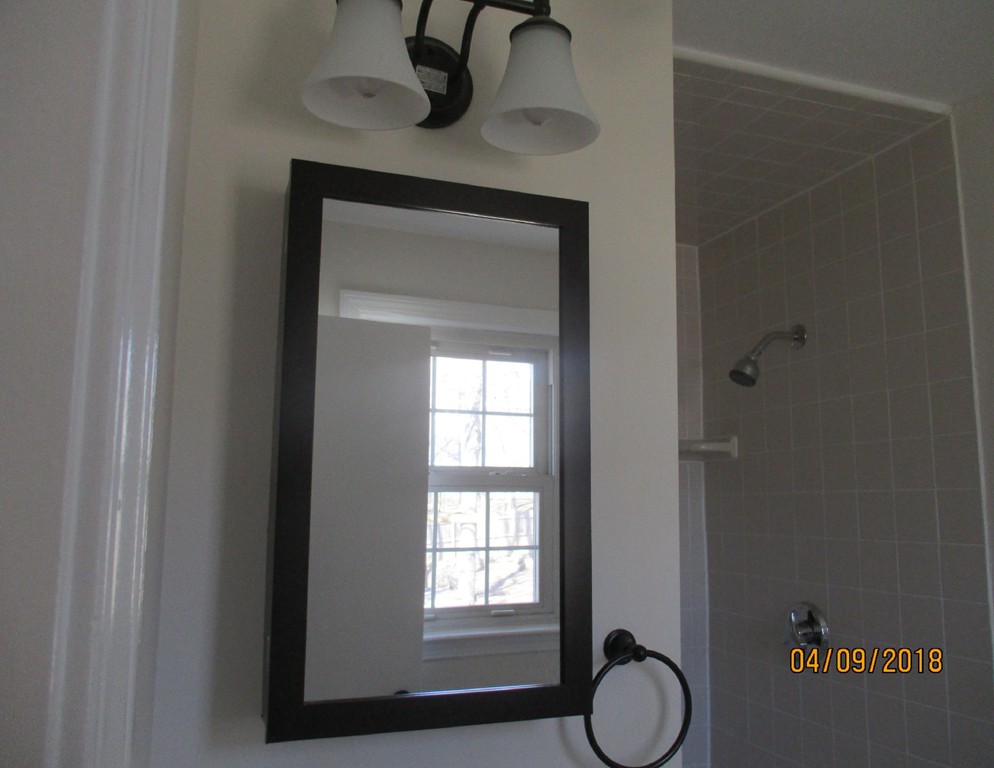 165 Swift Road Northbridge, MA 01588 - Photo 15 of 24 a bathroom with a light fixture and a window