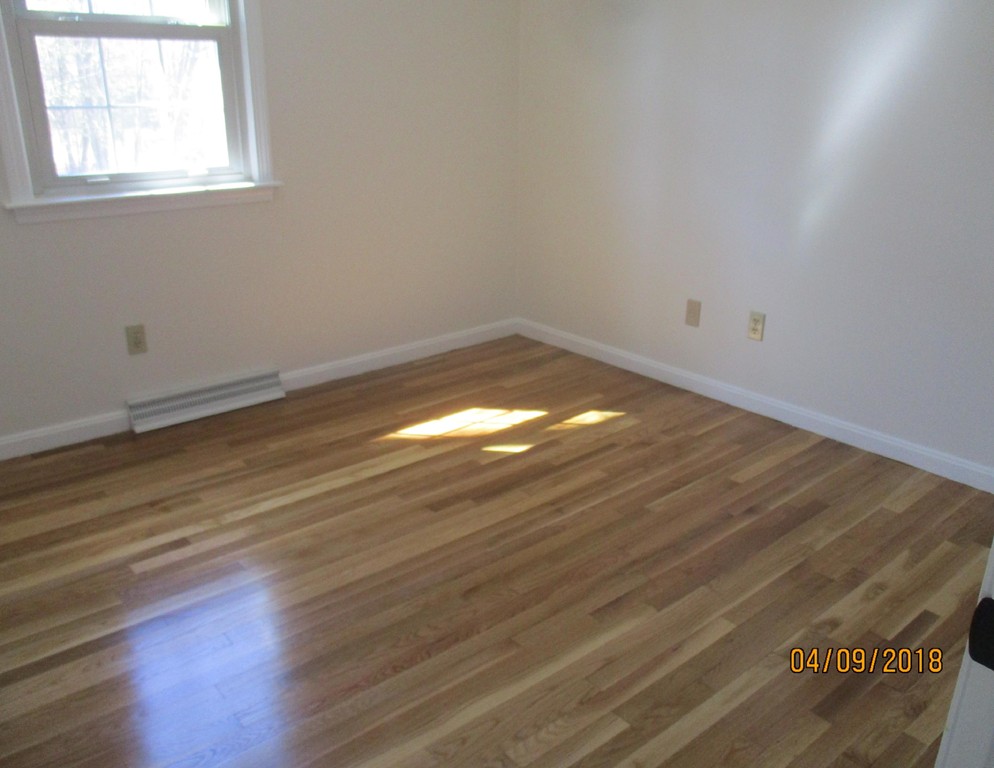 165 Swift Road Northbridge, MA 01588 - Photo 16 of 24 an empty room with wooden floor and windows