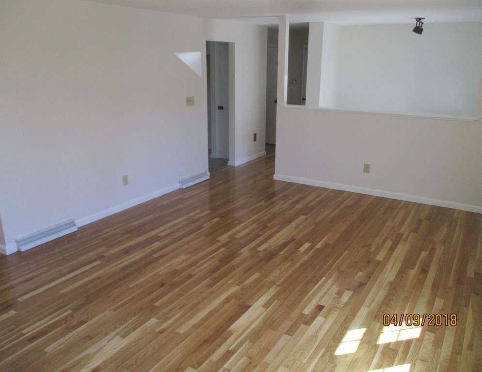 165 Swift Road Northbridge, MA 01588 - Photo 4 of 24 a view of an empty room with wooden floor