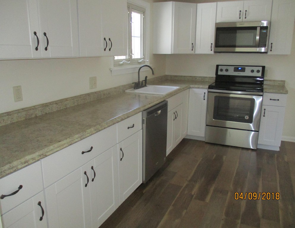165 Swift Road Northbridge, MA 01588 - Photo 8 of 24 a kitchen with sink a microwave and cabinets