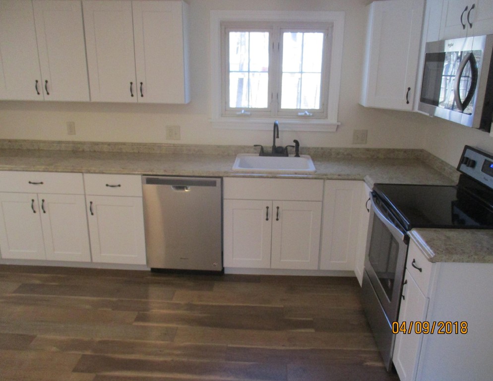 165 Swift Road Northbridge, MA 01588 - Photo 9 of 24 a kitchen with stainless steel appliances granite countertop a sink stove and cabinets