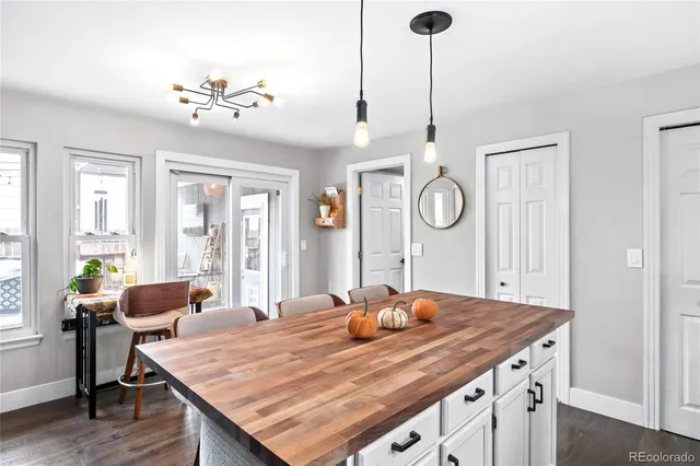 a dining table with chairs and window