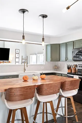 a kitchen with a table chairs and a sink