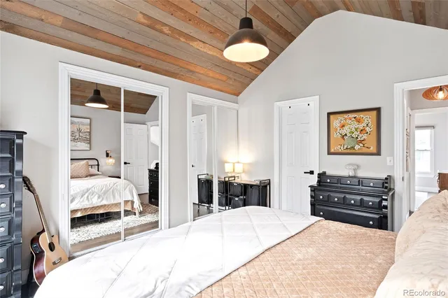 a bedroom with a bed and a chandelier