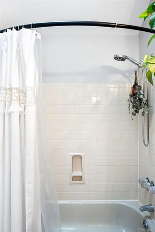 a bathroom with a shower curtain and a sink