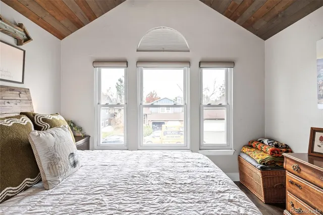 a bedroom with a bed and a window