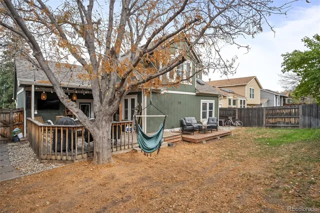 a view of a house with backyard and a tree