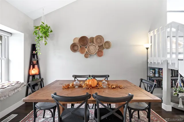 a view of a dining room with furniture and a potted plant