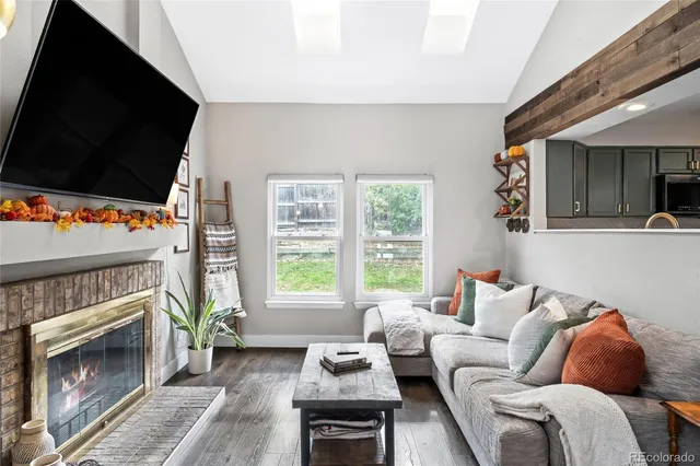 a living room with furniture a flat screen tv and a fireplace