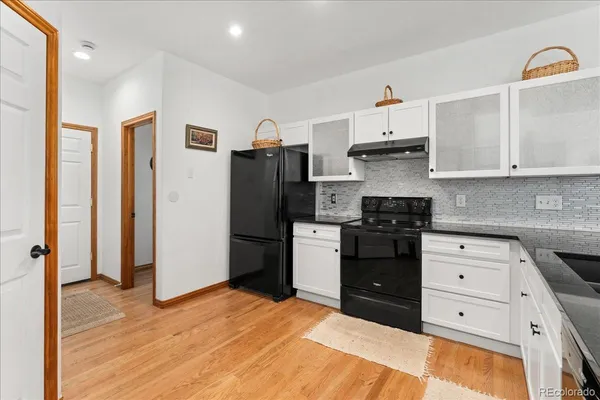 a kitchen with stainless steel appliances a refrigerator sink and cabinets