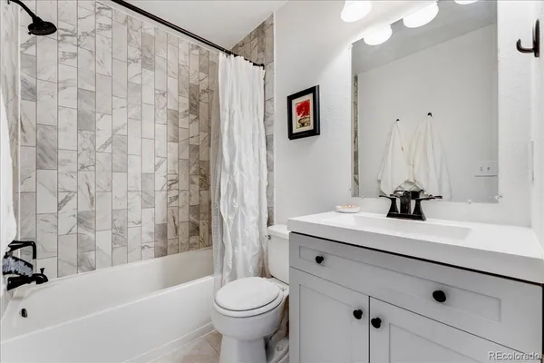 a bathroom with a sink a toilet and a bathtub